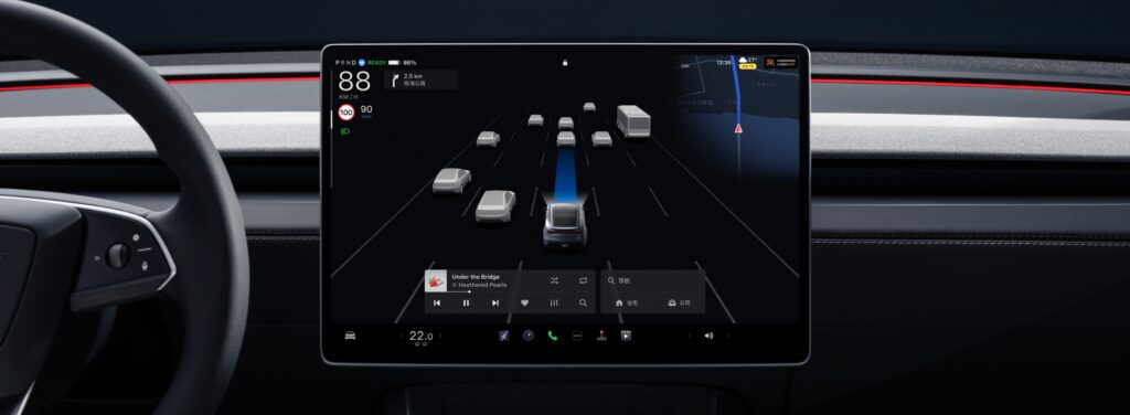 Close-up of Tesla Model Y’s central touchscreen displaying real-time navigation and advanced driver-assistance features.