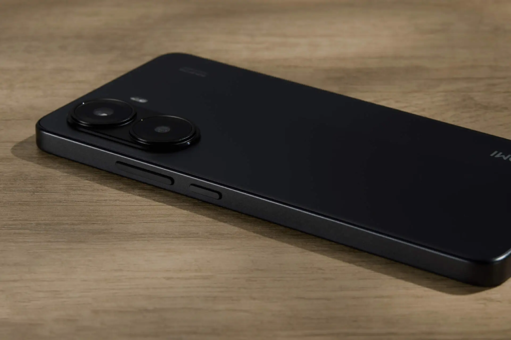 Xiaomi Redmi Turbo 4 showcasing its sleek black glass back design with dual-camera setup and a robust side frame.