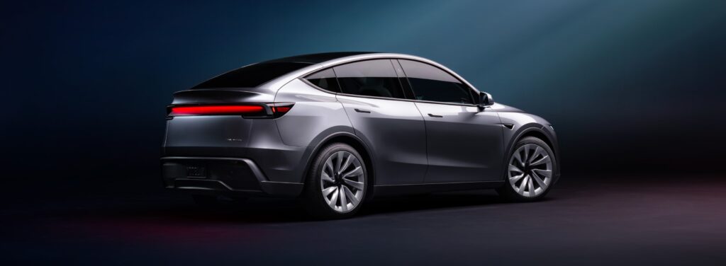 Side profile of the Tesla Model Y facelift in silver, emphasizing its aerodynamic silhouette and upgraded wheels.