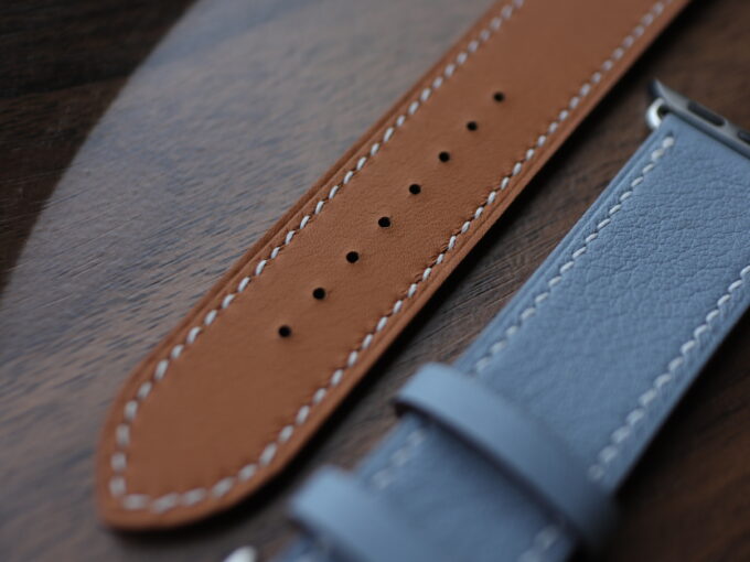 Close-up of the blue band’s front and tan underside, showcasing the smooth leather texture.