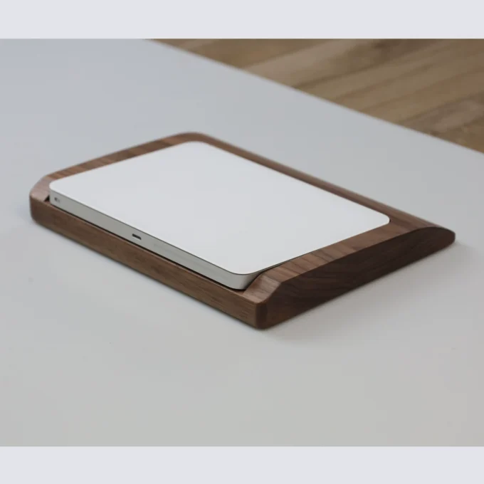 Side view of the walnut wood wrist rest tray, perfectly fitted to the Apple Magic Trackpad, highlighting its natural grain and protective design.