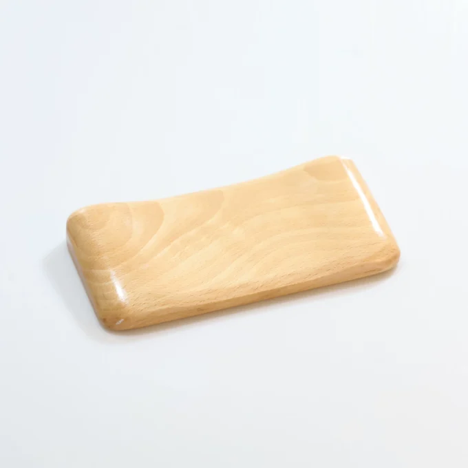 Another Artisan Wood Ergonomic Mouse Wrist Rest in a darker wood tone, placed on a white tabletop for contrast.