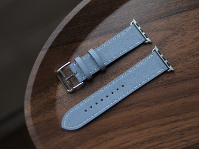 Angled shot showing the band’s slim profile and precise stitching along the blue leather.