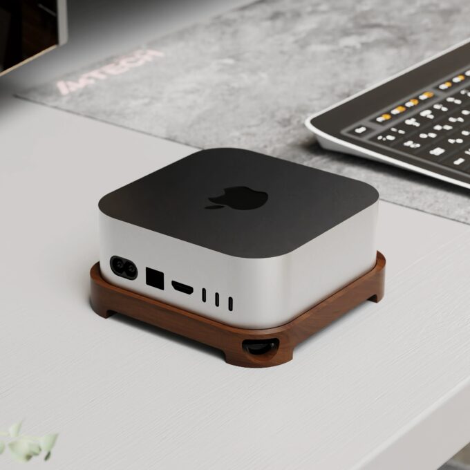 Close-up of a Mac Mini placed on a premium walnut stand featuring cutouts for air circulation and a minimalist design.