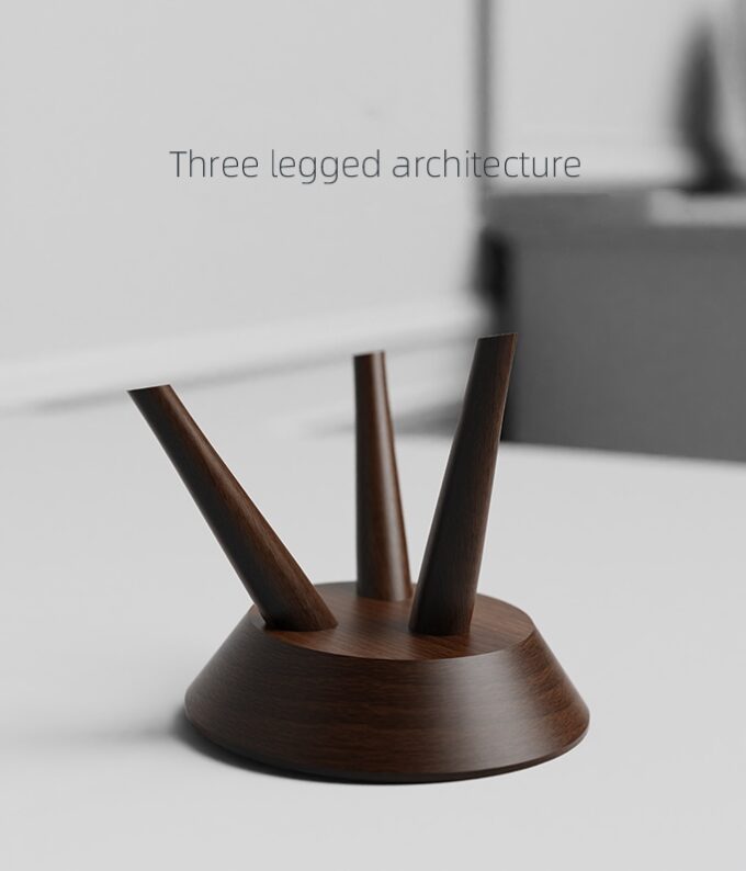 A detailed view of the walnut wood stand’s three-legged architecture, emphasizing stability and craftsmanship.