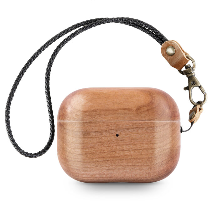 A cherry wood AirPods case with a clean, light finish, paired with a leather strap for easy carrying.