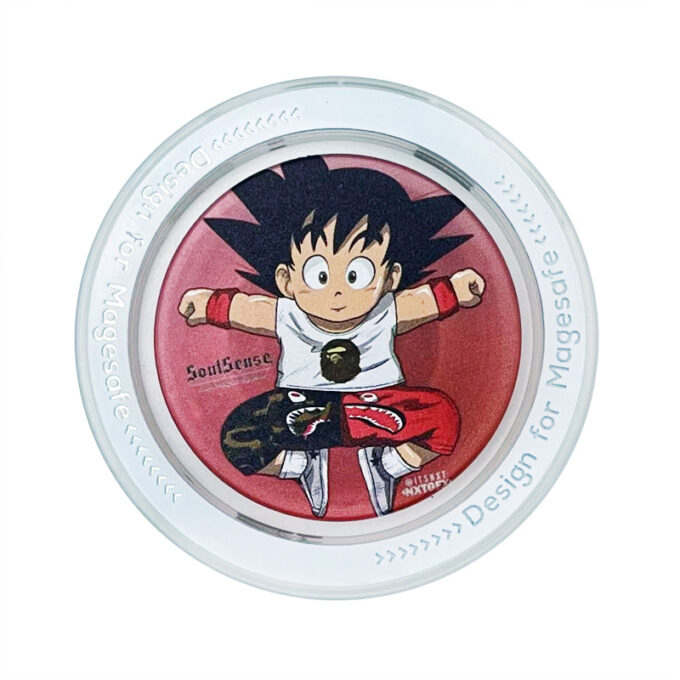 A close-up of a white MagSafe grip featuring Kid Goku in a martial arts pose against a red background.