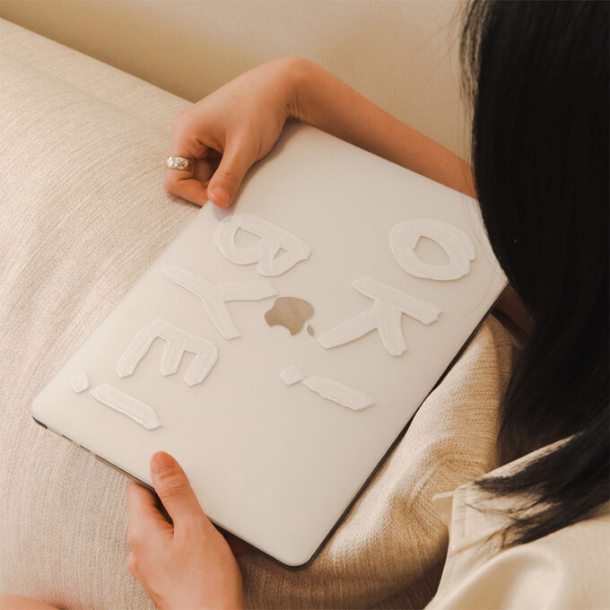 A MacBook in its protective case resting on a soft surface, highlighting its sleek and durable design.