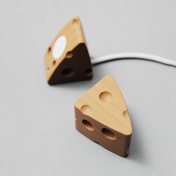 Multiple stands displayed together, emphasizing their cheese-inspired, playful shapes and compatibility with any Apple Watch charger.