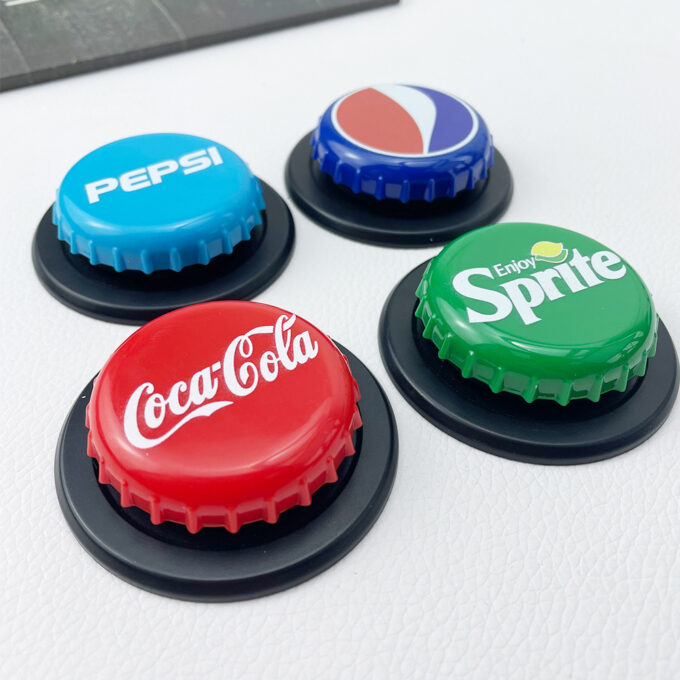 Four MagSafe bottle cap phone grips (Pepsi, Sprite, Coca-Cola) resting on a white table, each in a distinctive beverage-themed color.