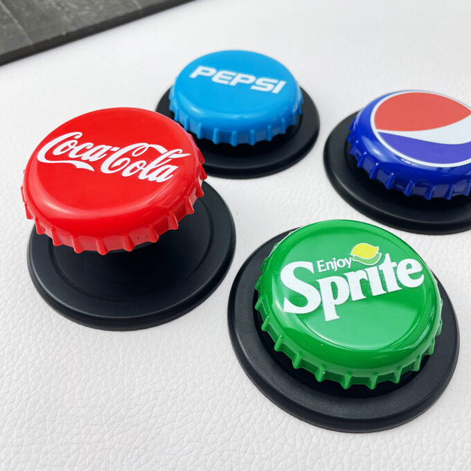 A lineup of Coca-Cola, Pepsi, and Sprite cap grips with their stands partially deployed, offering a nostalgic look.