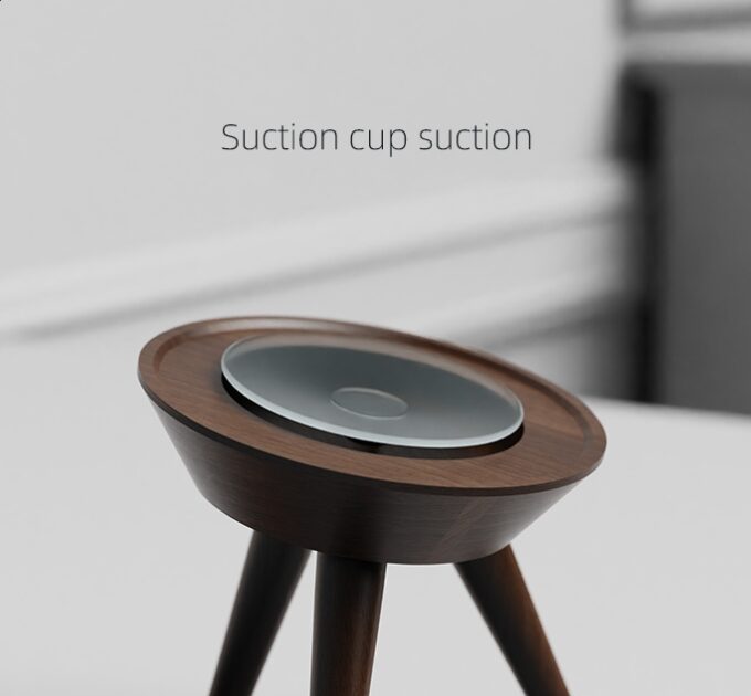 A walnut wood Mac Mini stand with suction cup feet for added grip, displayed on a clean surface.