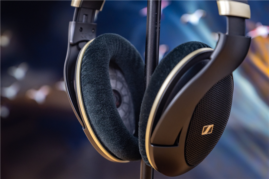 Sennheiser HD 505 open-back headphones on a stand, showcasing the lightweight 237-gram build and plush velour ear pads against a blurred background for audiophile appeal.