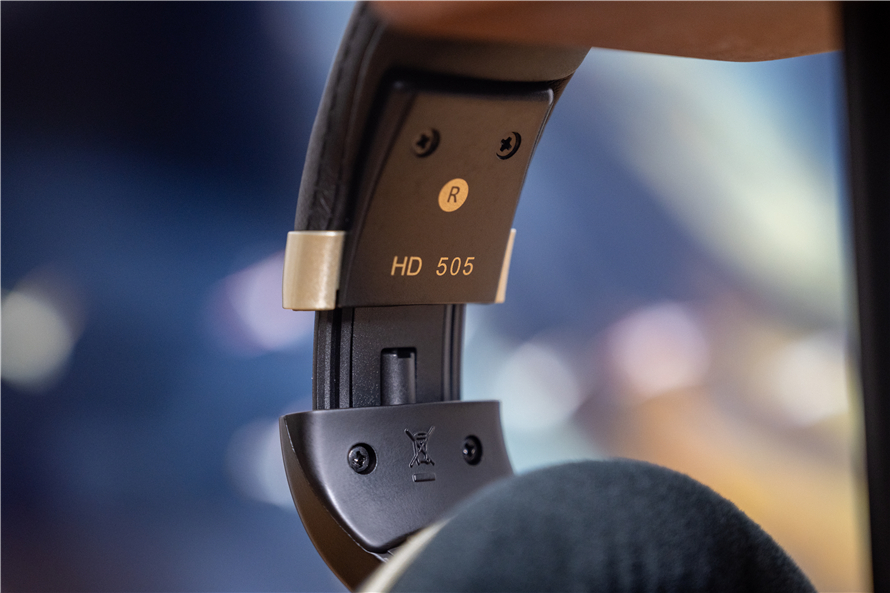 Close-up of Sennheiser HD 505 headphones with velour ear pads and adjustable headband, labeled "HD 505" on the side, emphasizing ergonomic design and comfort.